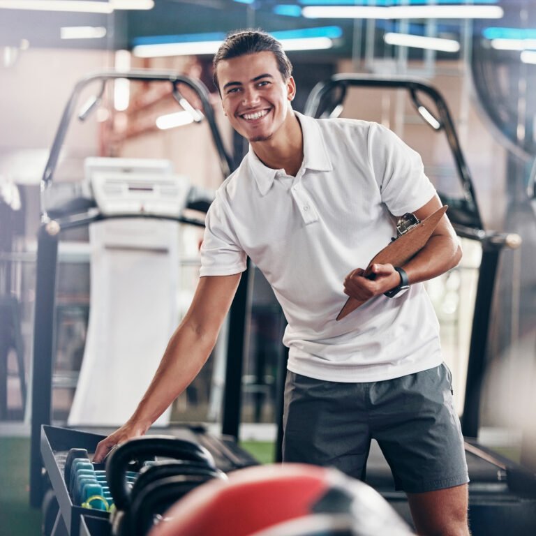 Training, portrait and fitness coach doing inspection of equipment at the gym. Wellness, sport and .