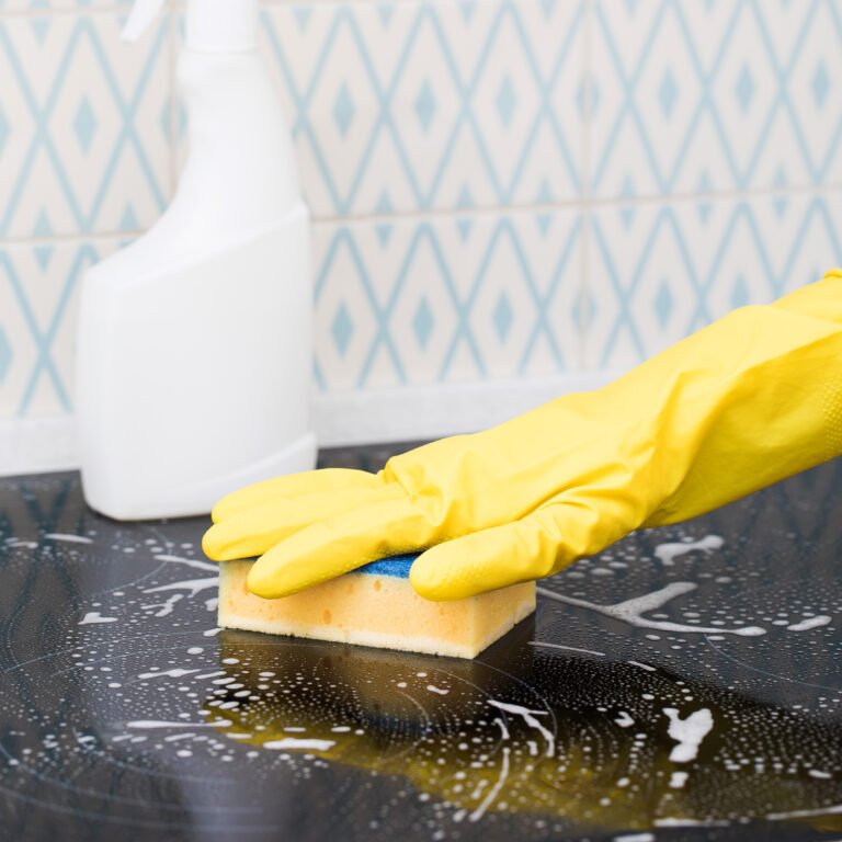 Yellow sponge on the stove in the foam. General cleaning concept. High quality photo